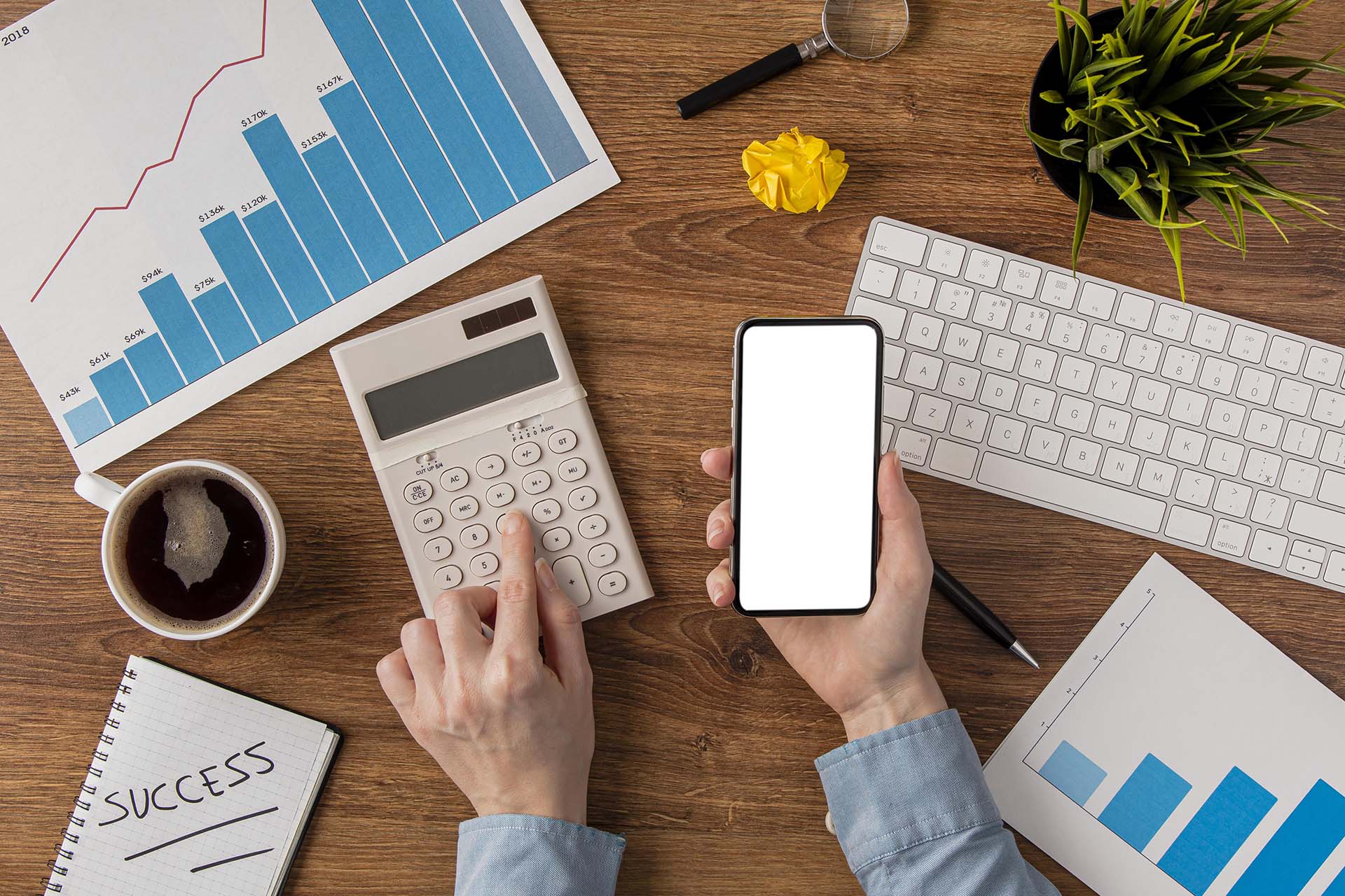 top view office desk with growth chart hands using calculator Resources